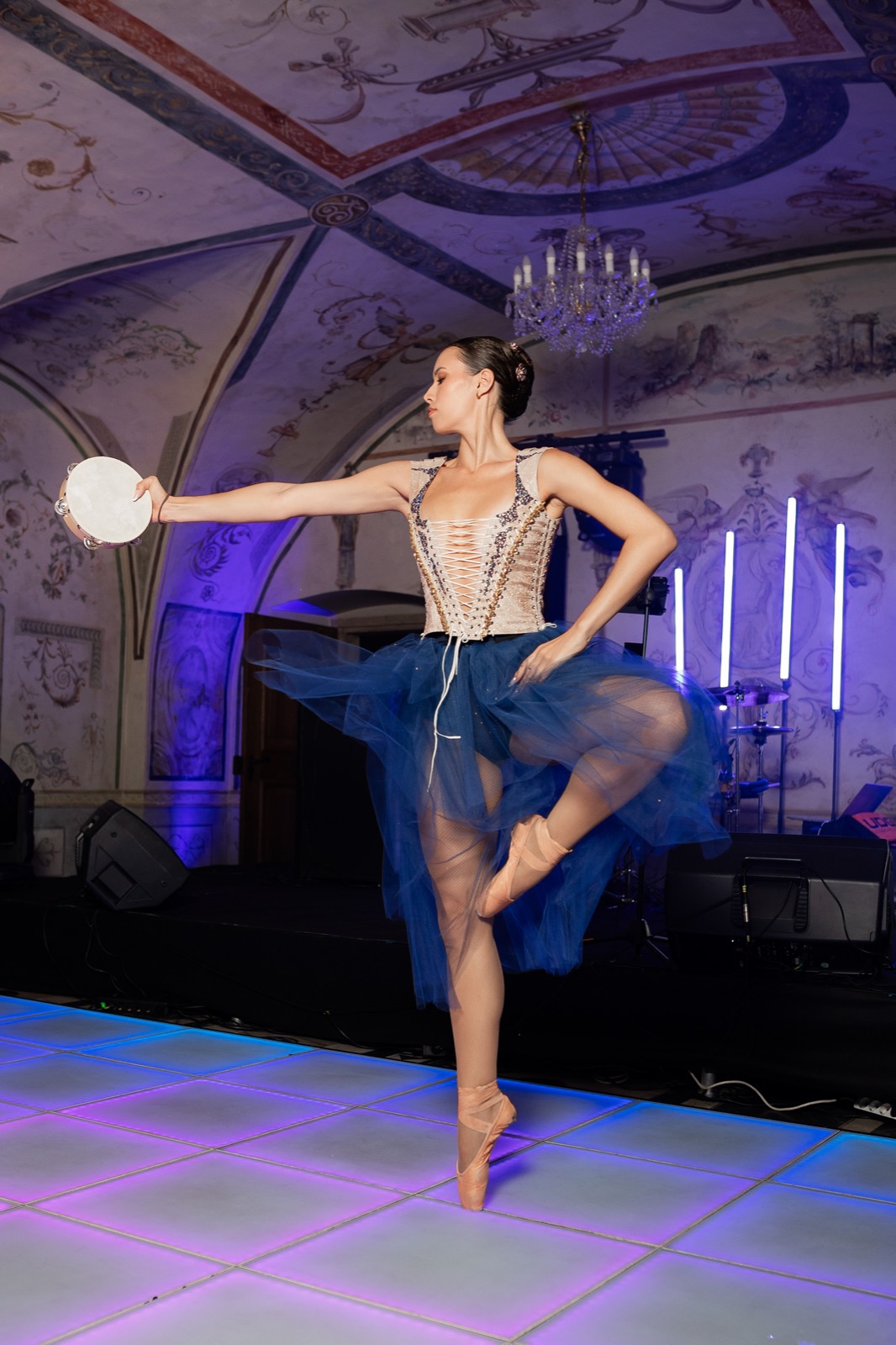 Ballerina performing en pointe in an ornate hall