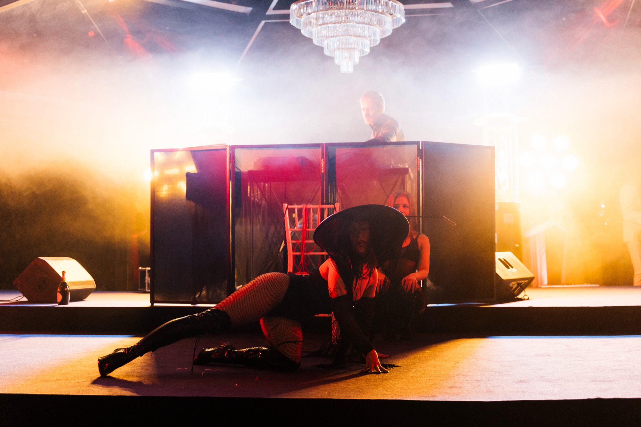Wide stage shot with smoke and a dramatic silhouette
