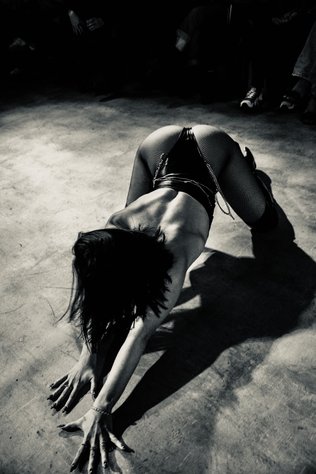 Black and white floor performance with dramatic shadow